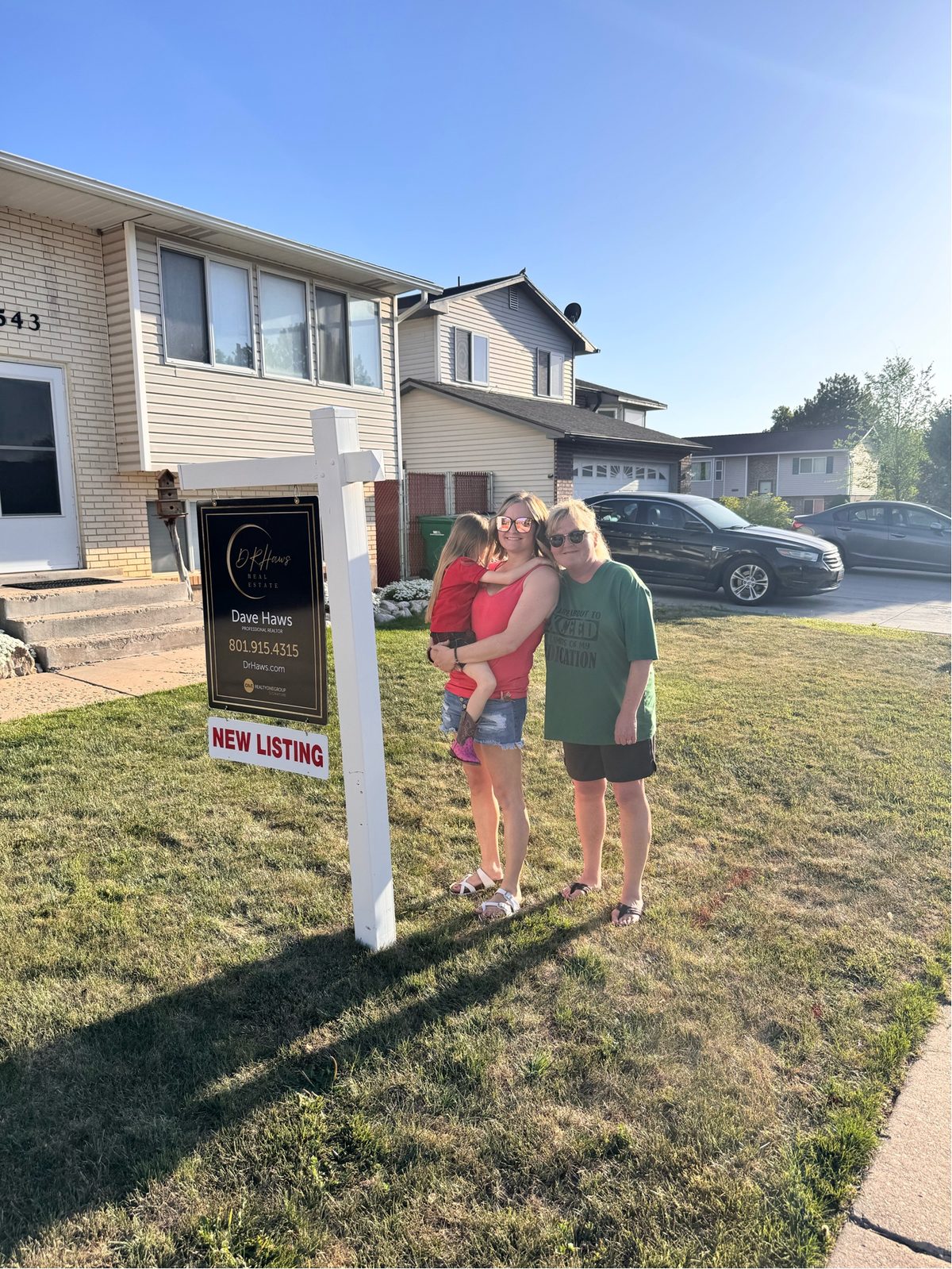 New Listing — family proud in front of the Dr. Haws sign